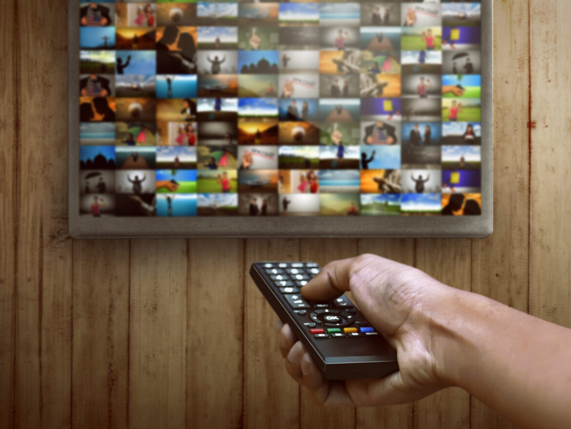 Smart tv and hand pressing remote control