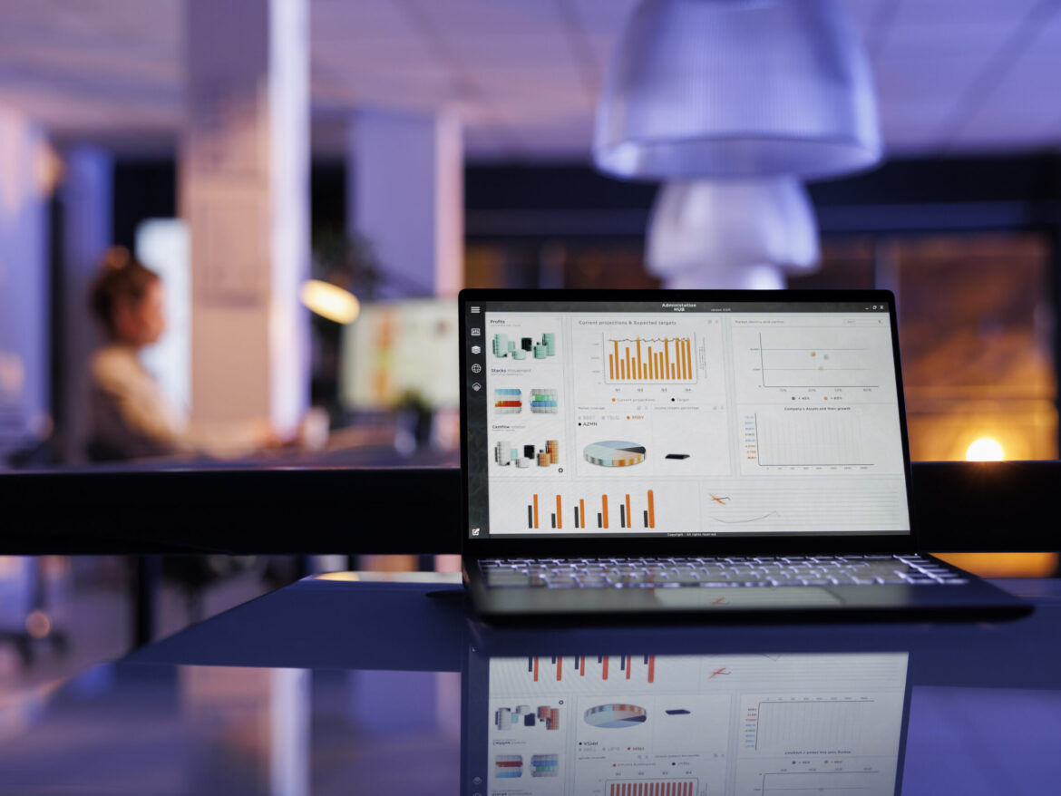 Laptop computer with company profit progress on screen