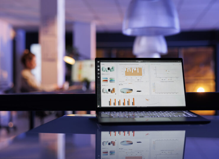 Laptop computer with company profit progress on screen